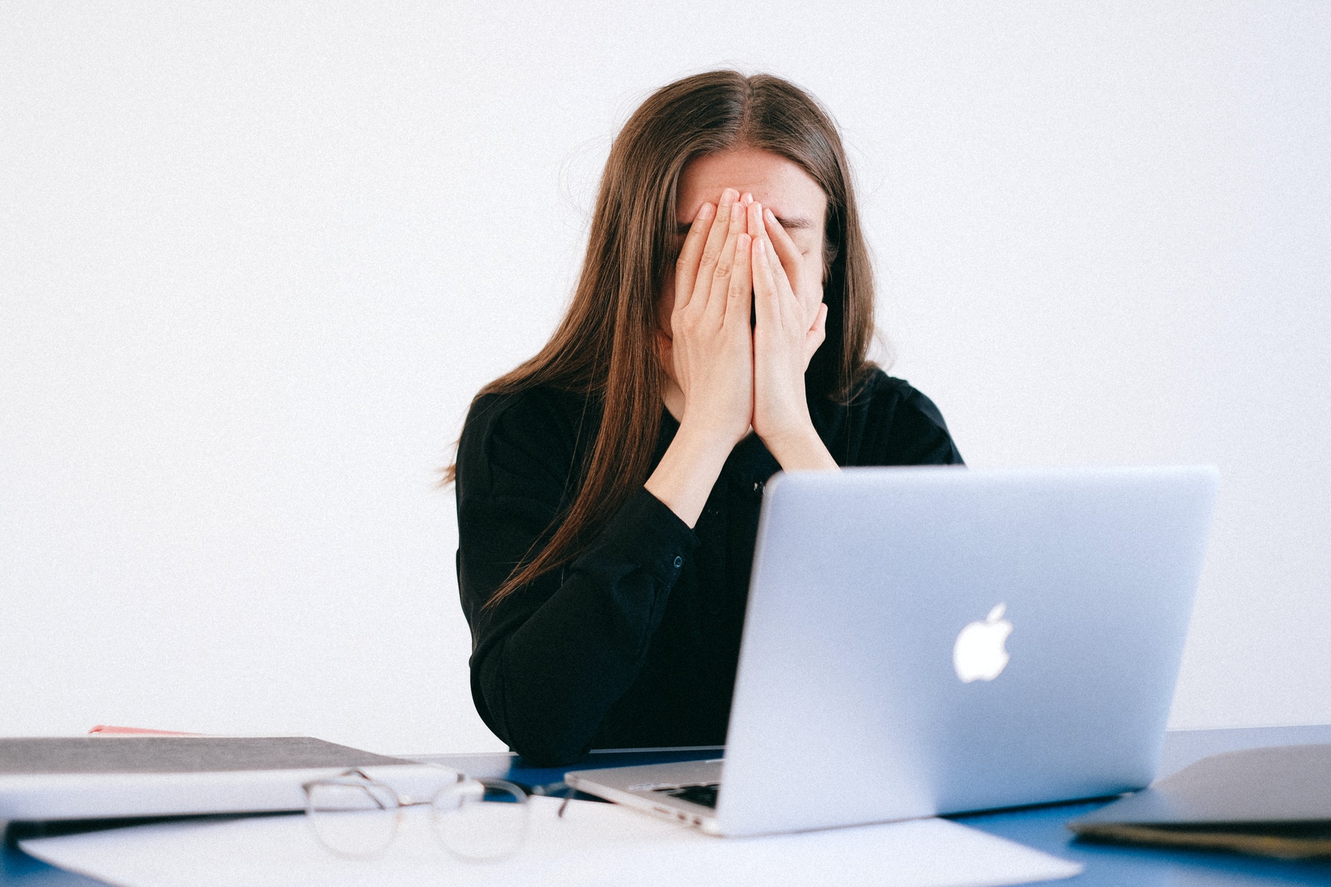 Stressed woman covering her face