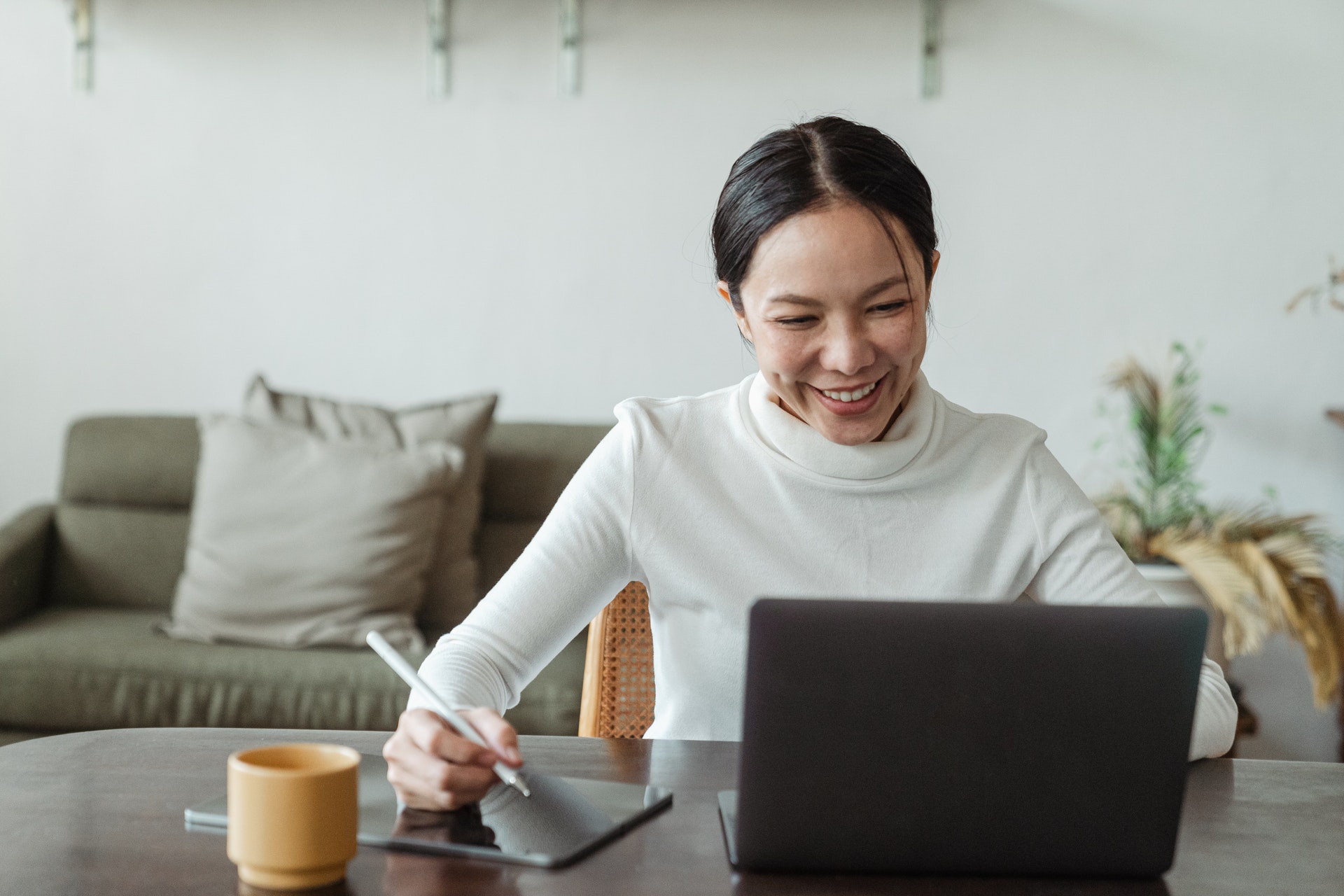 Woman happily looking at laptop