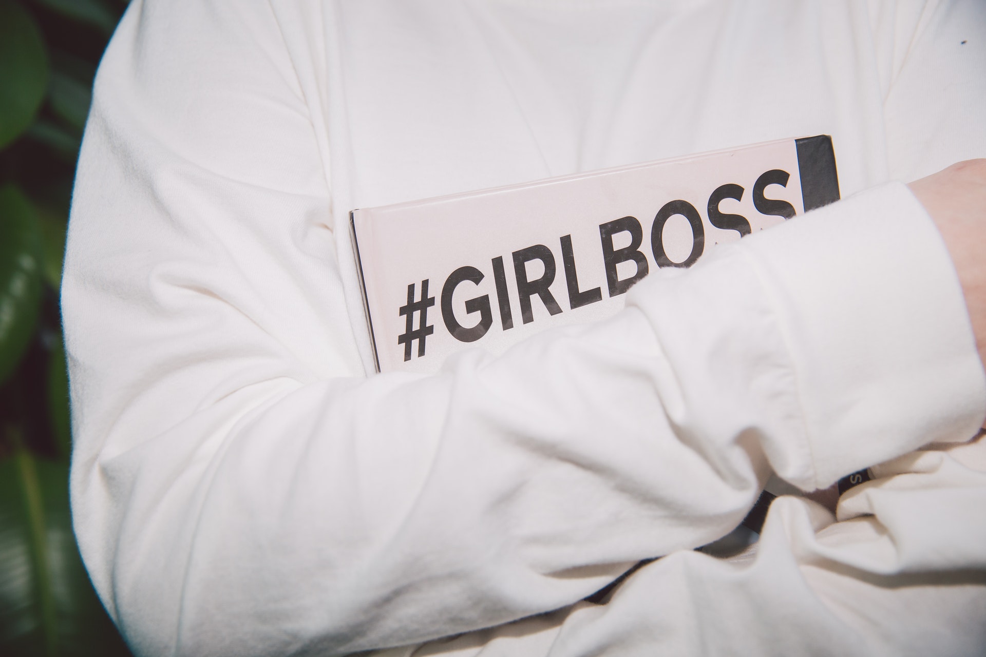 Person holding notebook with girlboss hashtag