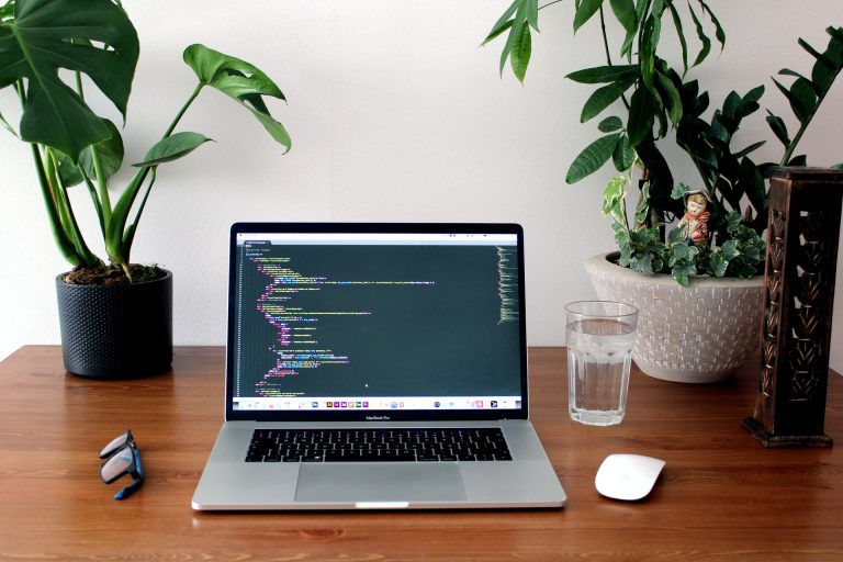 How to Fix Error While Parsing the Configuration File Laptop showing code editor on desk