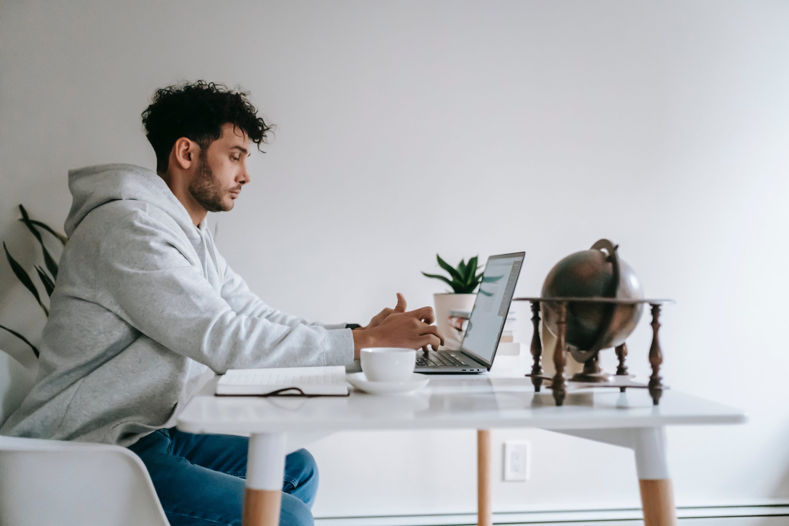 man typing on laptop