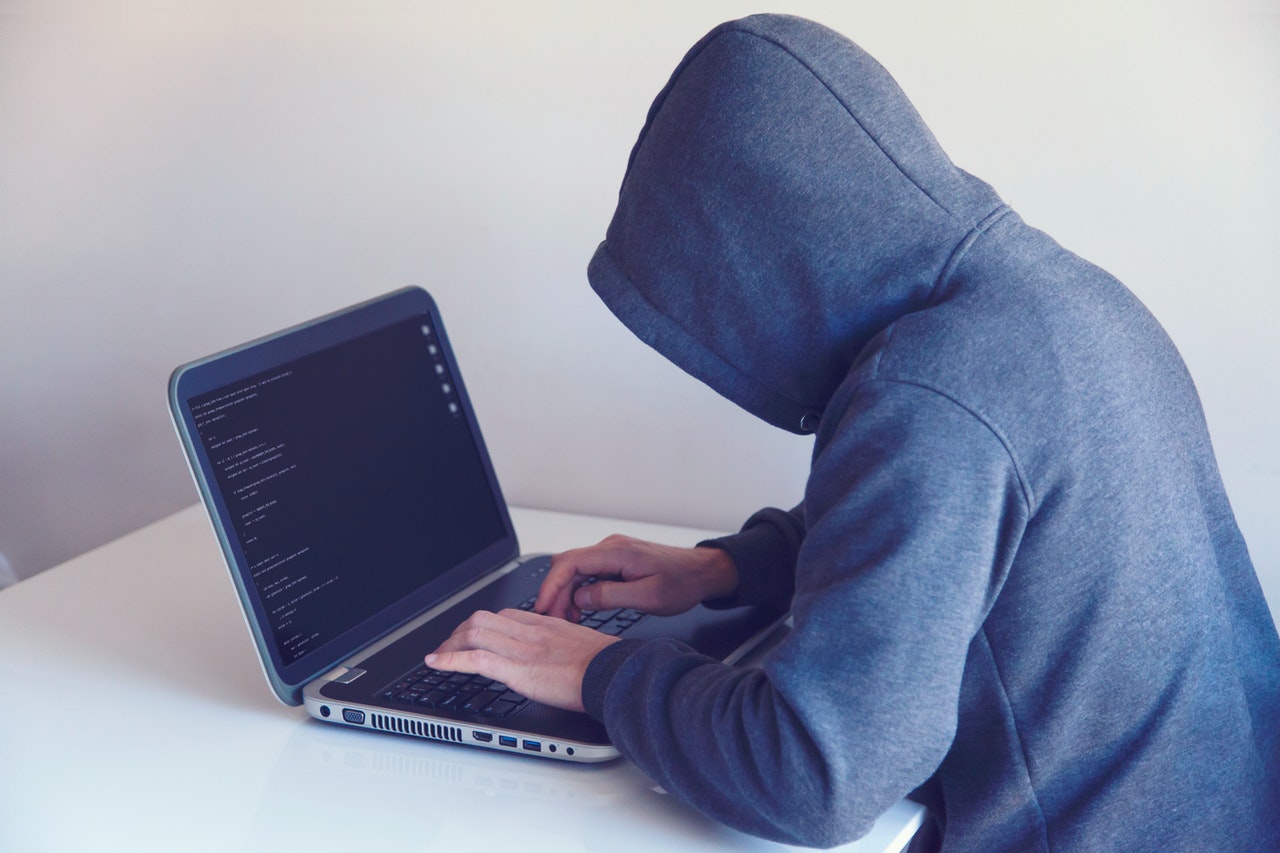 person with the hoodie using laptop