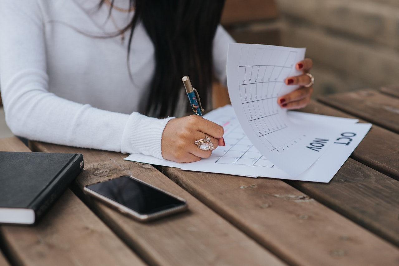 Woman taking notes in content calendar